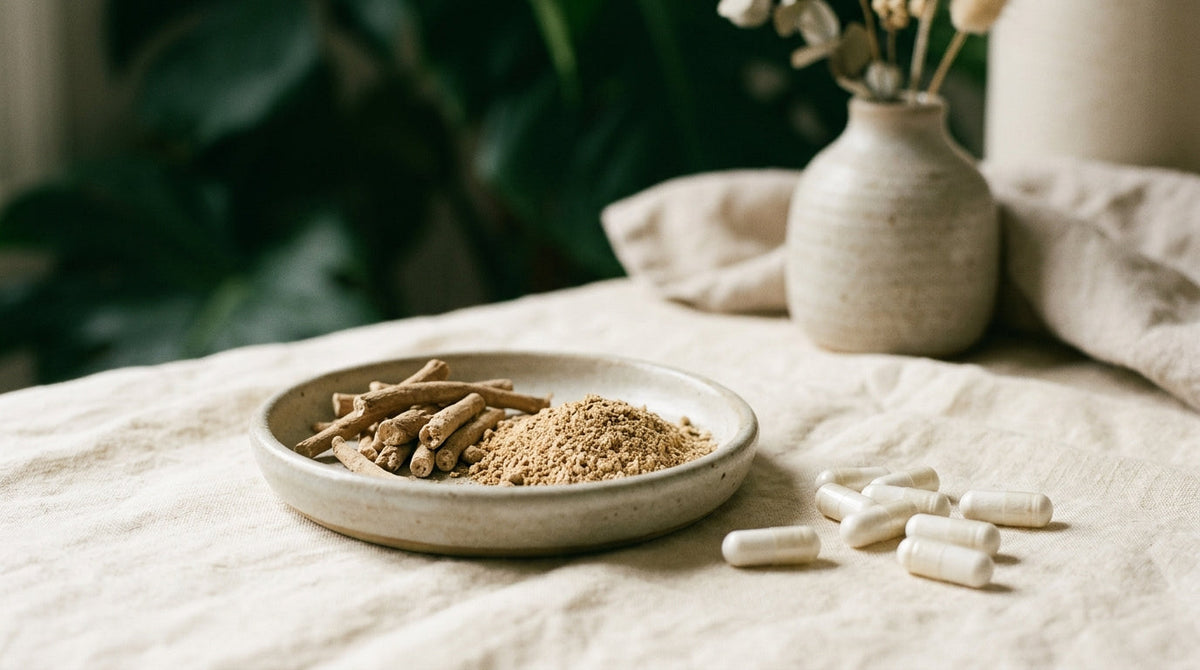 Ashwagandha root powder and white capsules arranged on cream linen in even daylight
