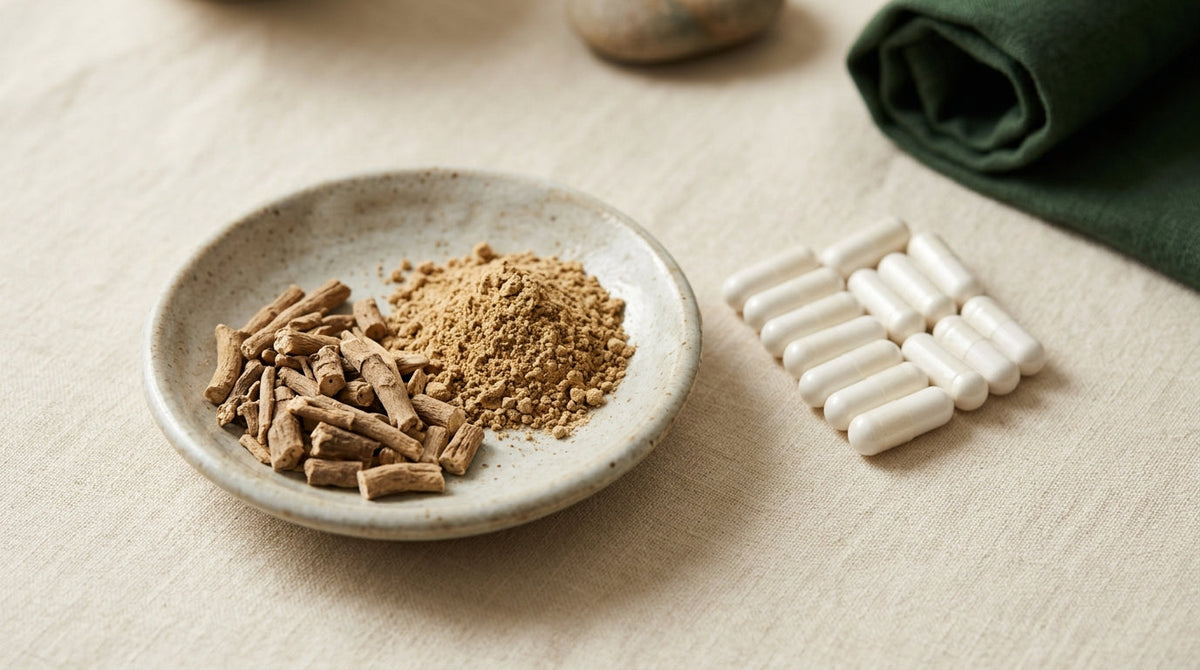 Ashwagandha root pieces, powder and capsules laid out precisely on a cream linen surface